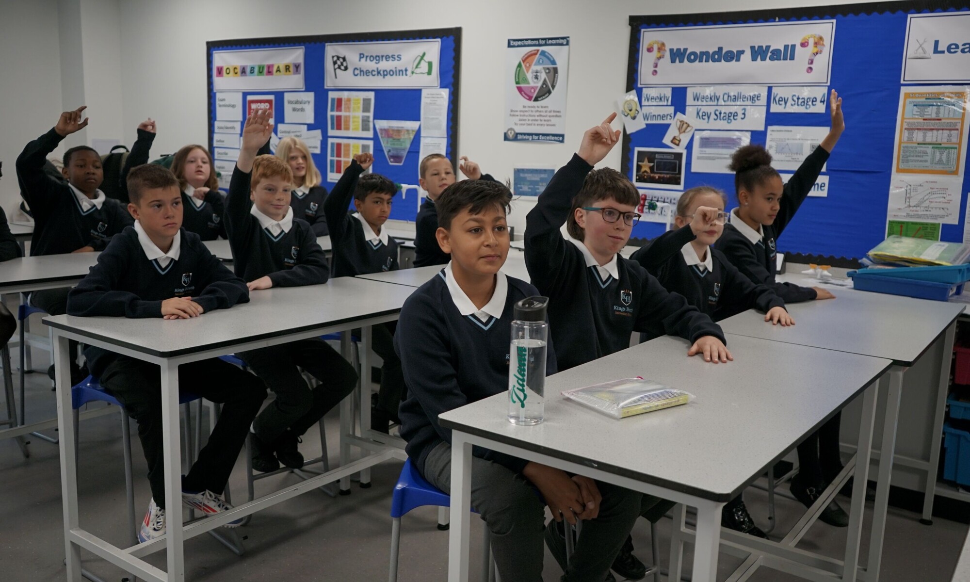 Kings Heath Secondary School Pupils raising hands in classroom